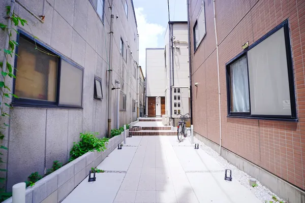 Walkway leading through the alley toward the building