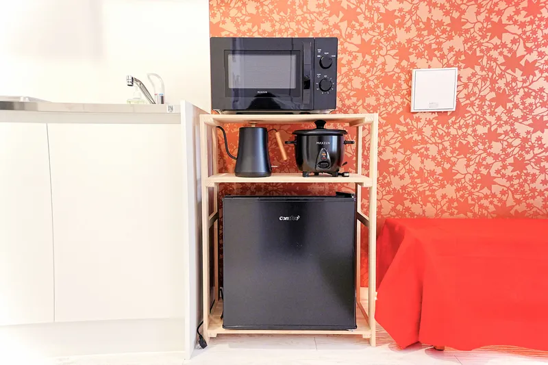 Sunset room - kitchen appliances including microwave and fridge