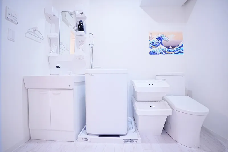 Sunset room - washroom with washing machine and toilet