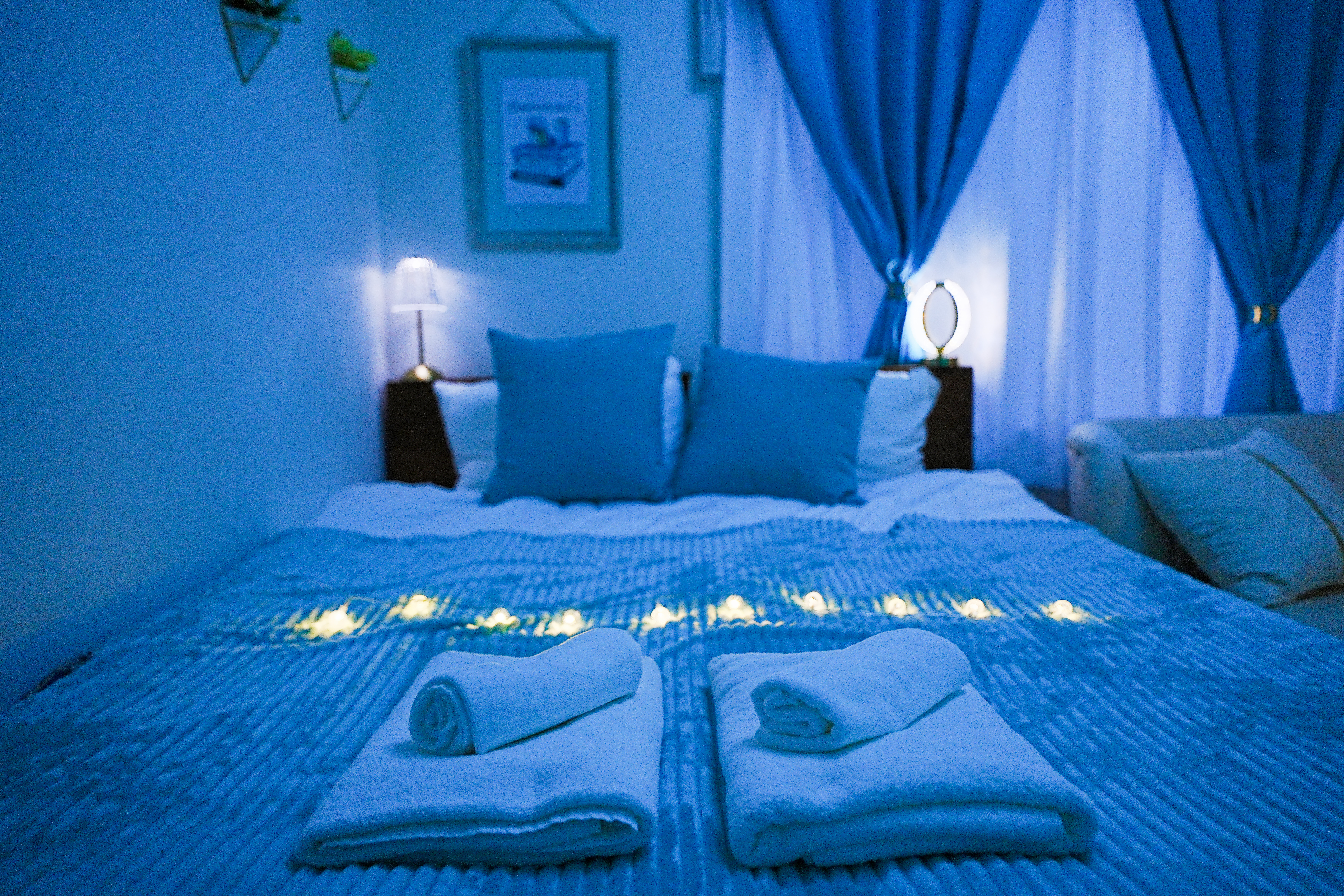 Blue Sky room - bed with fairy lights at night